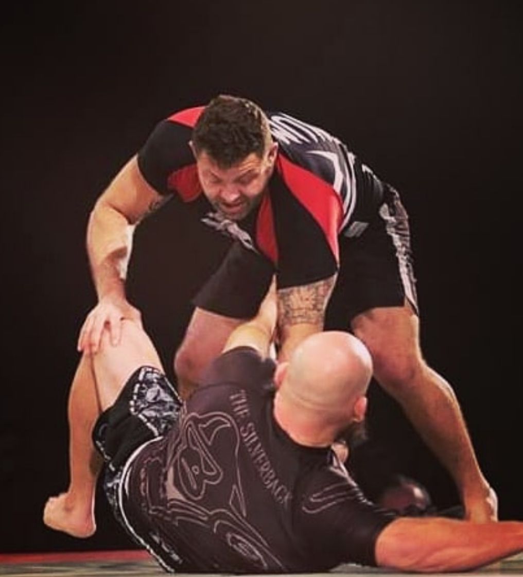 Two DMT athletes working through a Brazilian Jiu Jitsu position